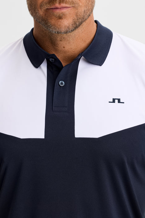 close up of the J.Lindeberg Calex Golf Polo Shirt on model in white and navy