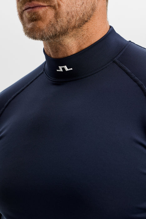 close up of model in the J.Lindeberg Ello Brushed Top Golf Base Layer in navy