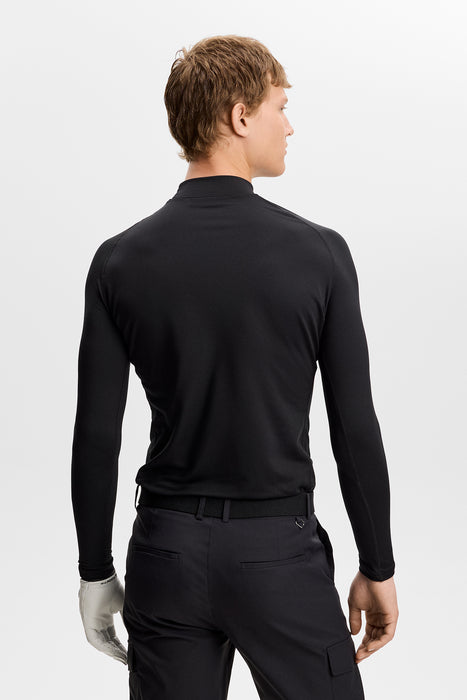 back of model wearing J.Lindeberg Ello Brushed Top Golf Base Layer in black