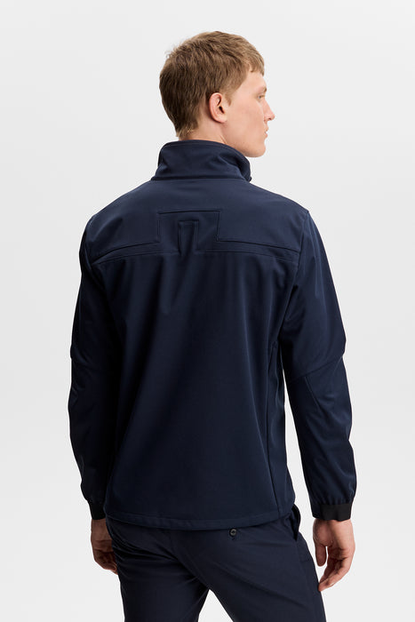 back of a male model wearing a J.Lindeberg Johnny Soft Shell Golf Jacket in navy, showing the JL logo across the back