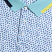 close up of buttons on the G/FORE Triple/G Tech Jersey Golf Polo Shirt in white/blue/yellow