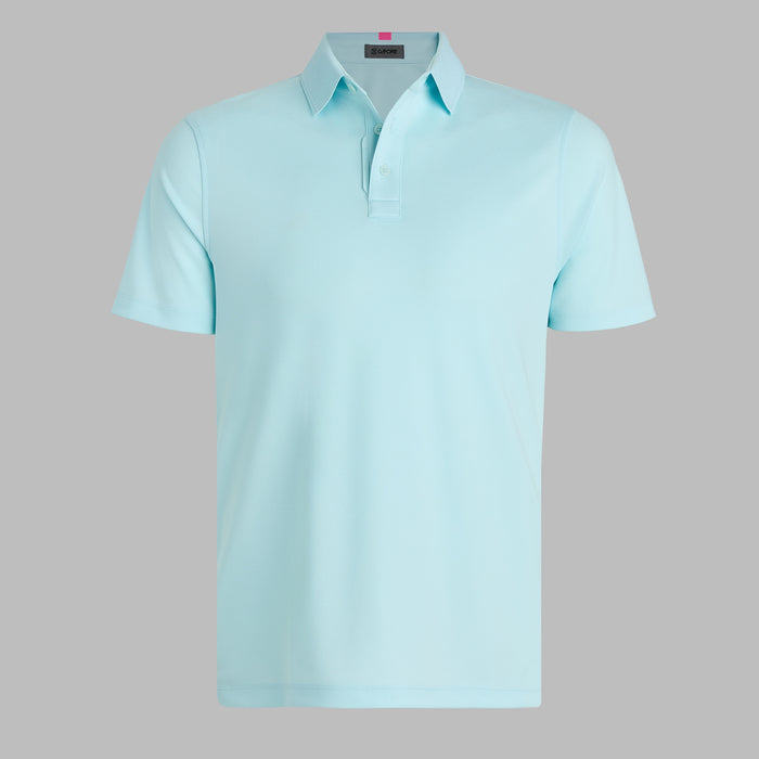 G/FORE Essential Performance Golf Pique Polo in daybreak light blue. Front of the polo on grey background 