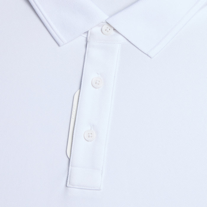 G/FORE Essential Performance Golf Pique Polo in snow white, close up of gfore logo