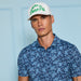 G/FORE Scattered Ditzy Tech Jersey Golf Polo Shirt in navy and blue on model wearing gfore white hat