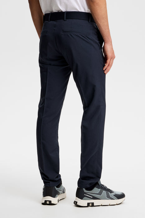 J.Lindeberg Elof Golf Trousers in JL navy on model, showing the rear side and rear packets