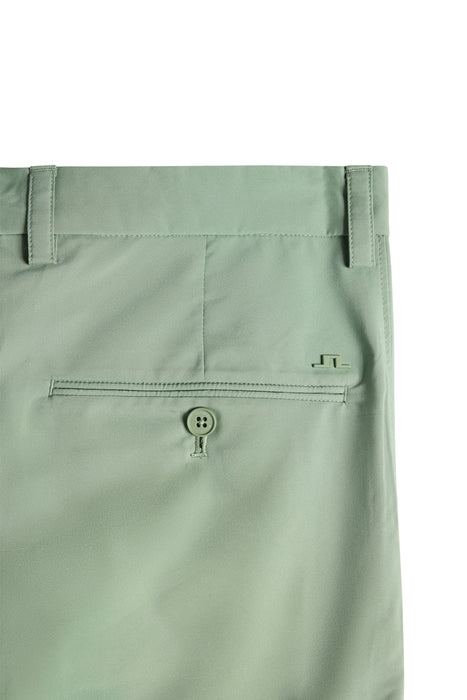 J.Lindeberg Mitch Golf Shorts in hedge green, close up of metal tag JL logo and back pocket