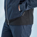Side view of a navy and black PING AquaDrive waterproof golf jacket featuring a SensorDry logo and zip pocket.
