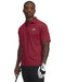 Man wearing a red patterned Under Armour polo shirt on a white background