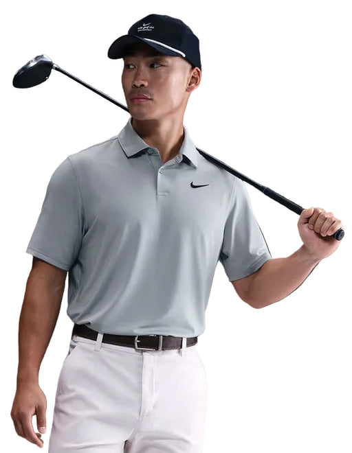 Nike Velocity Solid Golf Polo Shirt in wolf grey the plain nike golf polo on a model holding a golf club
