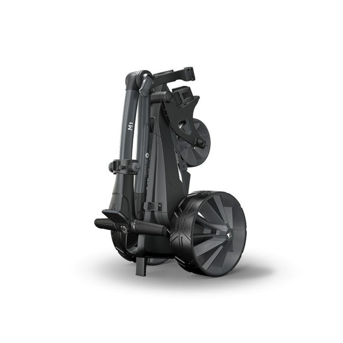 The Motocaddy M1 Electric Golf Trolley 2026 in its folded position on its stand