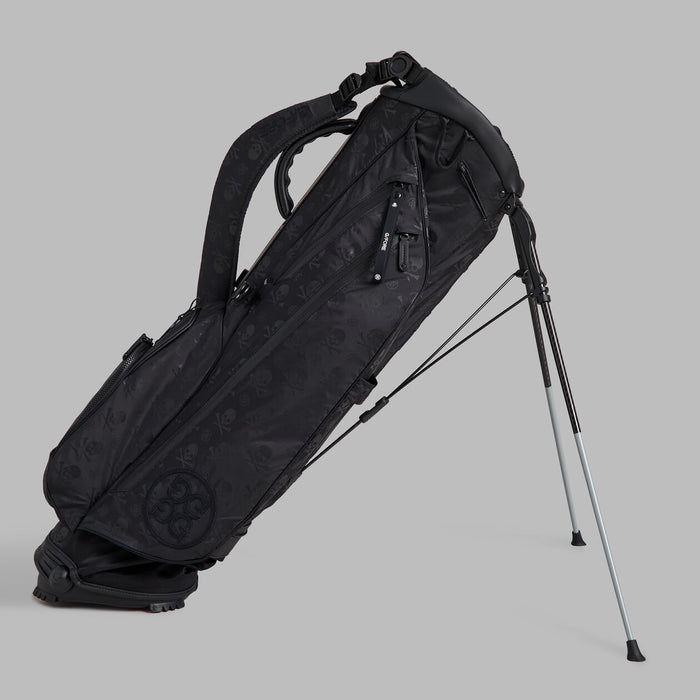 Side profile of the G/FORE Scrambled Skull & Tees Parachute Golf Stand Bag in black