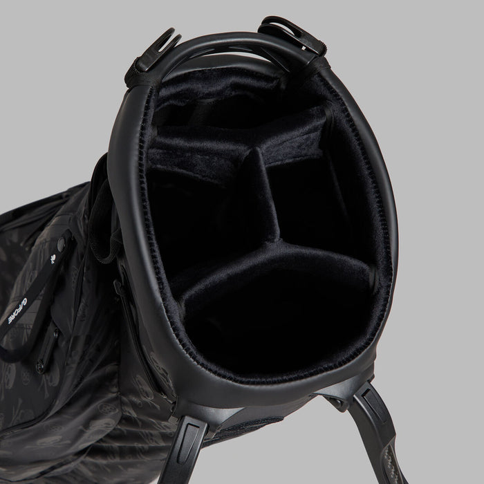 close up of the top divider of the G/FORE Scrambled Skull & Tees Parachute Golf Stand Bag in black