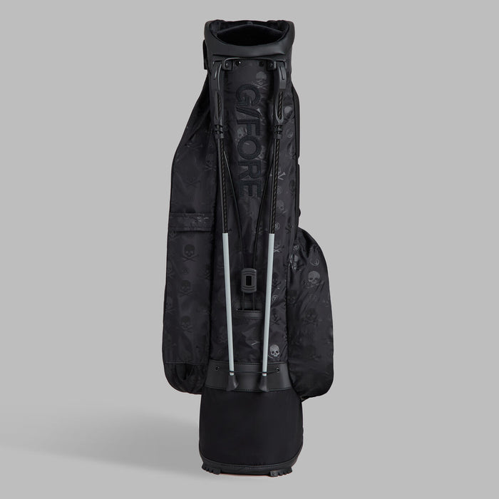 legs stand of the G/FORE Scrambled Skull & Tees Parachute Golf Stand Bag in black