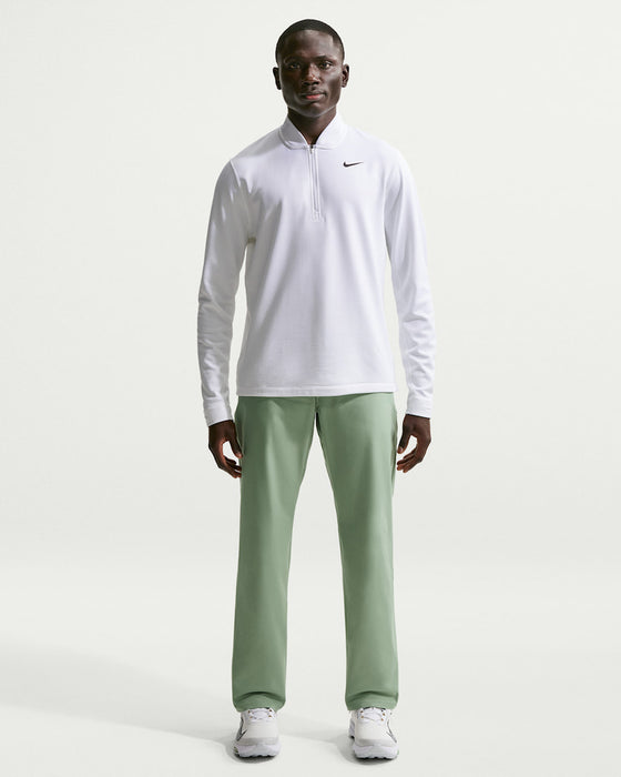 male model wearing Nike Velocity 5 Pocket Golf Trousers in green and white nike golf sweatshirt