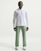 male model wearing Nike Velocity 5 Pocket Golf Trousers in green and white nike golf sweatshirt