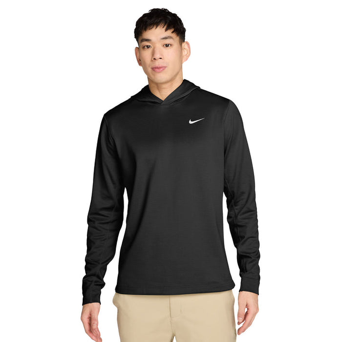 male model wearing the Nike Velocity Golf Hoodie in black with beige trousers