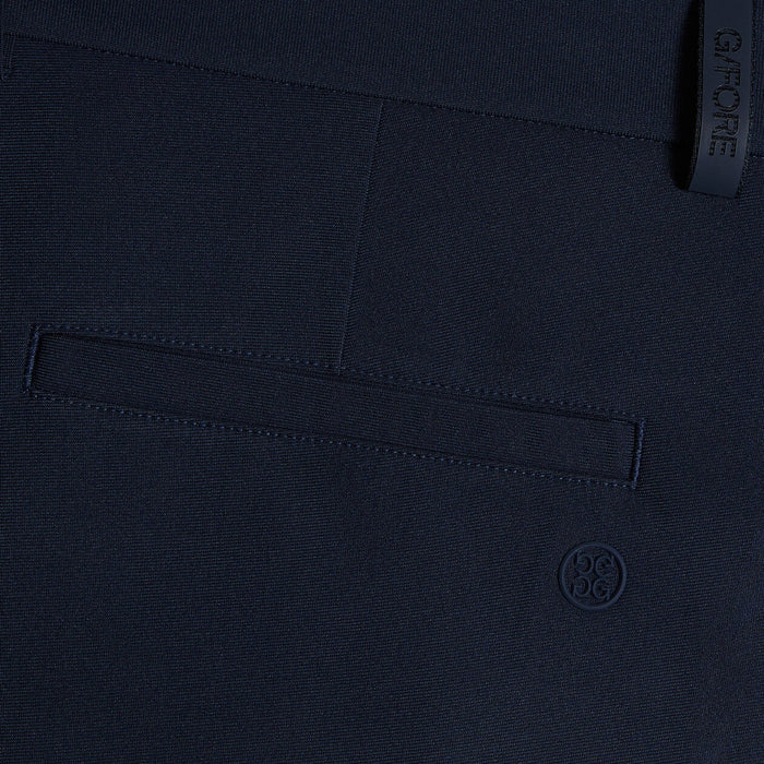 G/FORE Tour Golf Shorts in navy, close up on the back pocket and gfore logos
