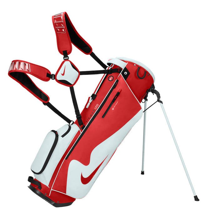Nike Air Max Lite Golf Stand Bag in red and white on its stand with straps up