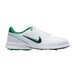 White golf shoe with green accents on a white background