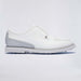 A white leather G/FORE Gallivanter Leather Brogue Men's Spikeless Golf Shoes with perforated details, a small silver-tone logo badge on the side, and a white sole with visible golf club tips, shown against a light grey studio background.