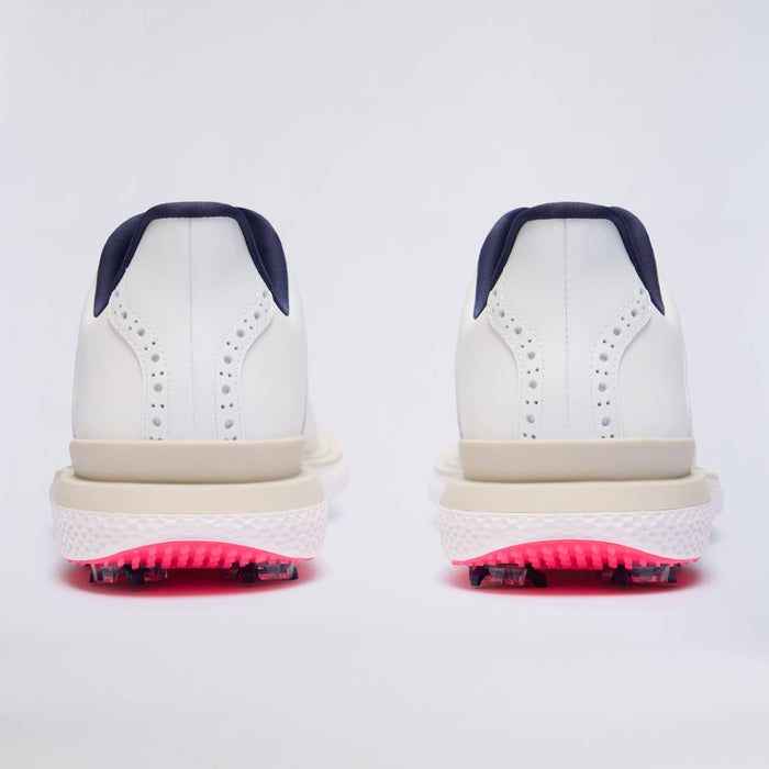 A pair of G/FORE Gallivan2R Brogue Saddle Men's Golf Shoes shown from the back, featuring navy blue heel tabs, beige midsoles, and bright pink spiked outsoles.