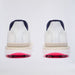 A pair of G/FORE Gallivan2R Brogue Saddle Men's Golf Shoes shown from the back, featuring navy blue heel tabs, beige midsoles, and bright pink spiked outsoles.