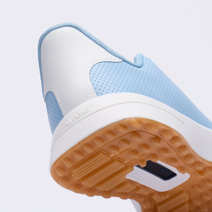 Close-up of a light blue and white G/FORE G.112 Perforated Men's Spikeless Golf Shoes showing the heel, side panel, and gum outsole.
