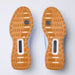Top-down view of a pair of aG/FORE G.112 Perforated Men's Spikeless Golf Shoes showing their tan and white outsoles against a light white background.