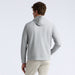 A man shown from the back wearing a light grey G/FORE Pebble Quilted Men's Golf Hoodie and beige pants against a clean white studio background.