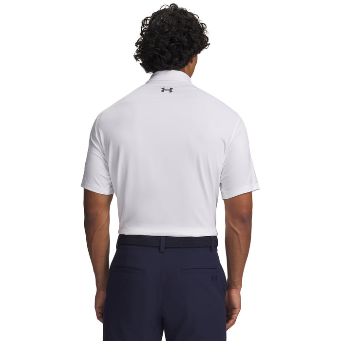 Person wearing a white Under Armour polo shirt and navy trousers on a white background