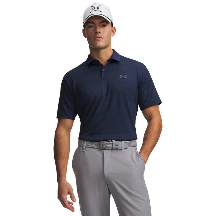 Man wearing a navy Under Armour polo shirt and grey trousers on a white background