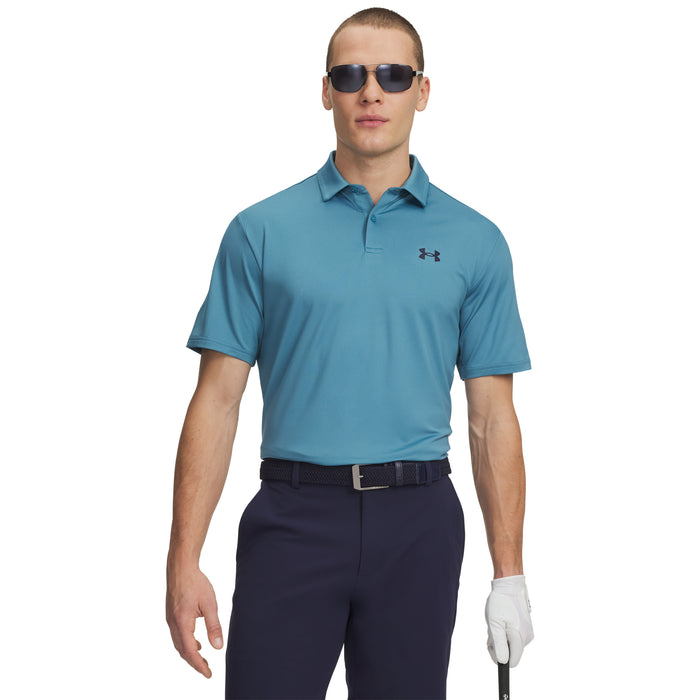 Man wearing a blue Under Armour polo shirt and navy trousers on a white background