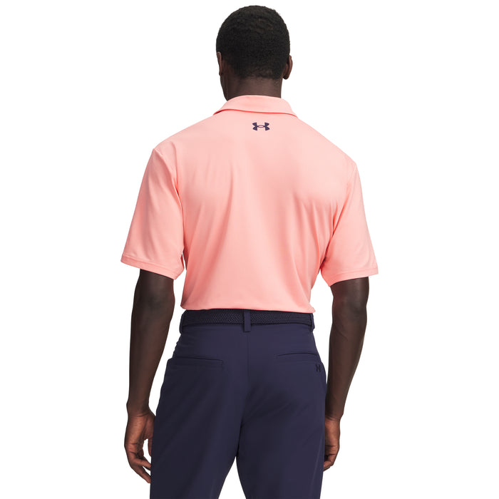 Person wearing a pink Under Armour polo shirt and navy trousers on a white background