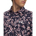 Under Armour Matchplay Printed Polo Golf Shirt in navy and pink floral pattern showing close up of ua logo on model
