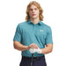 Under Armour Matchplay Printed Polo Golf Shirt in light blue pattern on model front facing holding a golf club