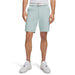 A model wearing Under Armour Drive Golf Shorts in 2026 colour, enamel blue with a white belt. front facing 