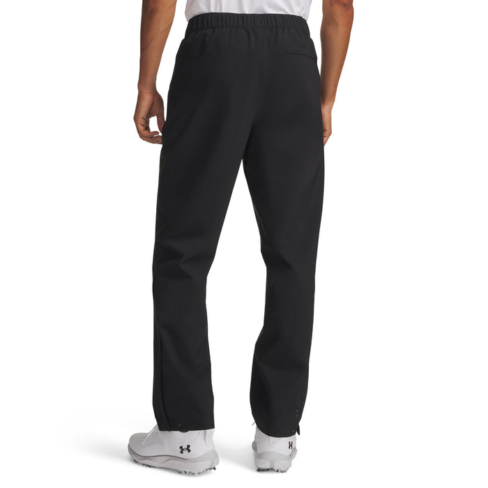 Back view of black Under Armour Drive Pro waterproof golf trousers with an elasticated waistband and zip-leg detailing.