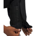 Close-up of black Under Armour Drive Pro waterproof golf trousers showing the zipped leg hem and Storm Proof branding.