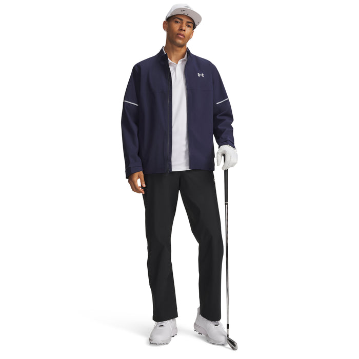 Under Armour Drive Pro waterproof black golf trousers worn by a male golfer in a full-length front view.