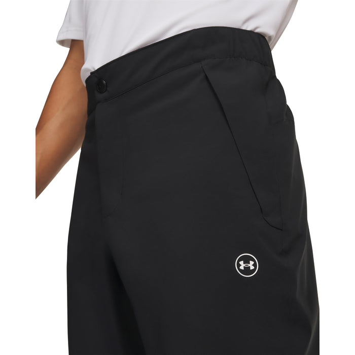Under Armour Drive Pro waterproof golf trousers in black, featuring a side pocket and white logo detail.