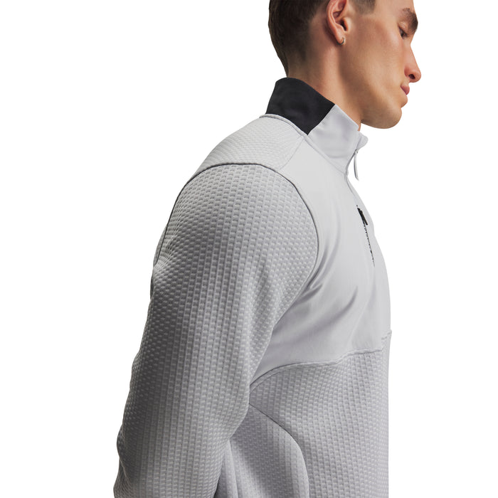 Side view of a light grey Under Armour Drive Pro Hybrid half-zip golf midlayer with textured fabric panels.