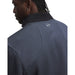 Under Armour Drive Pro Hybrid golf jacket in navy blue with a geometric pattern and rear logo detail.