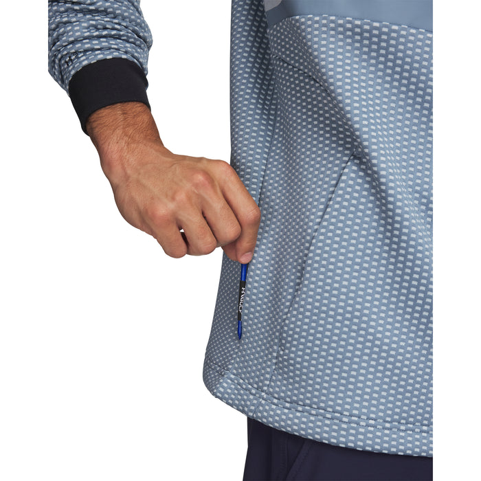 Under Armour Drive Pro Hybrid golf hoodie in blue with a textured pattern, showing a side pocket and black cuff detail.