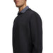 Under Armour Drive men's black crew neck golf midlayer, side view showing textured fabric and subtle chest logo.
