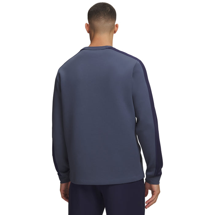 Back view of Under Armour Drive men's crew neck golf midlayer in blue with dark navy sleeve detailing.