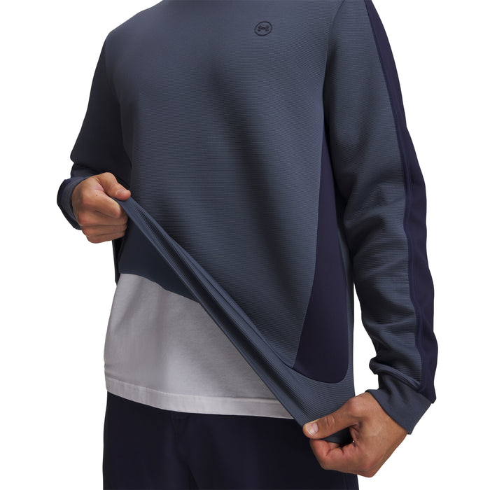 Under Armour Drive men's crew neck golf midlayer in navy blue, showing textured fabric and side panel detail.