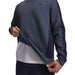 Under Armour Drive men's crew neck golf midlayer in navy blue, showing textured fabric and side panel detail.