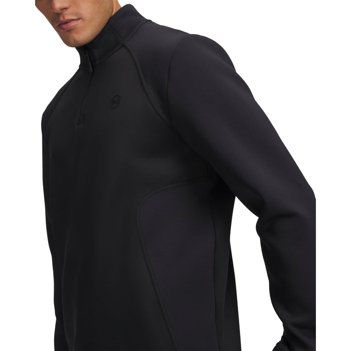 Under Armour Drive men's black quarter-zip golf midlayer, showing a close-up side view of the textured fabric design.