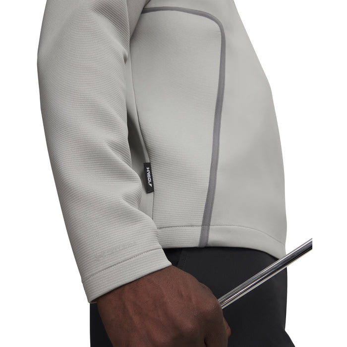 Side view of a light grey Under Armour Drive men's golf midlayer showing textured fabric and a small branded side tab.